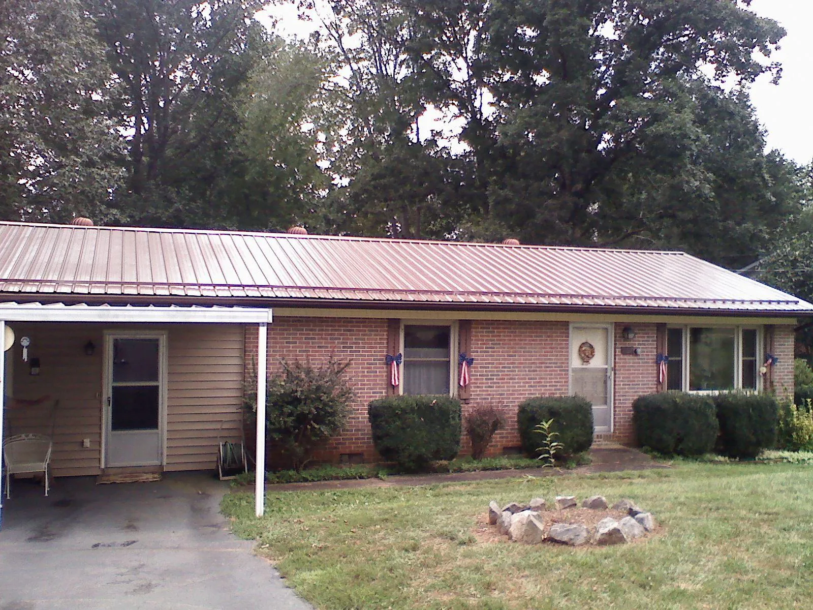Bronze metal roof and carport on a brick ranch home — Roof Repair work by our crew in Mission Viejo